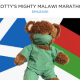 Photo of teddy bear wearing hospital scrubs and face mask in front of Scotland and Malawi flags