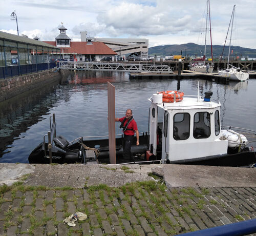 Man in a boat in Dunoon harbour - Fynewood delivery by Cowal Rothesay depot