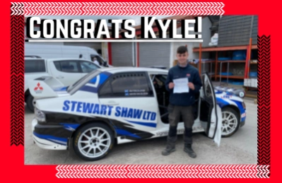 Congrats Kyle photo of Kyle next to a Shaw Stewart car