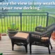 decked garden area with wicker chairs overlooking large green field - cowal building garden decking